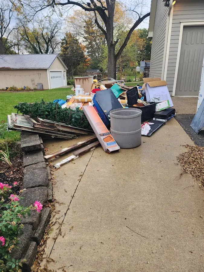 Dumpster being loaded with debris for 10 Yard Dumpster Rental in Bisbee